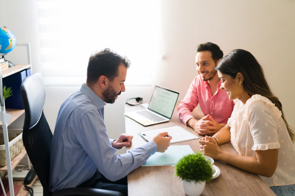 A financial advisor discussing papers with a couple
